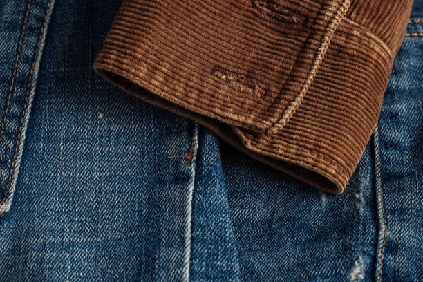 corduroy sleeve on jeans. The corduroy sleeve on the old jeans. corduroy jacket stock pictures, royalty-free photos & images