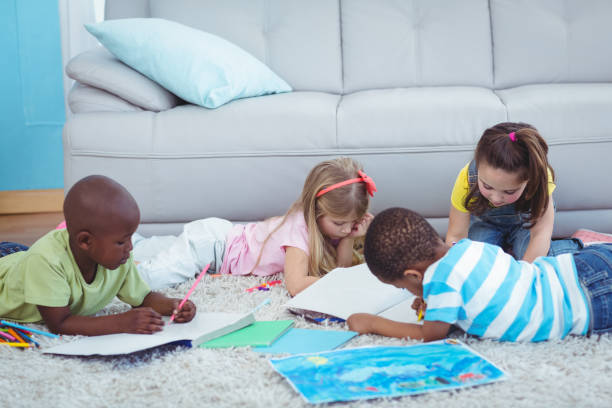 istock Smiling kids drawing pictures on paper 664170744