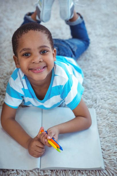 istock Smiling kids drawing pictures on paper 664171210
