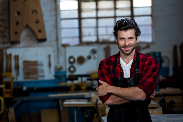 istock Carpenter smiling and crossing arms 664174604