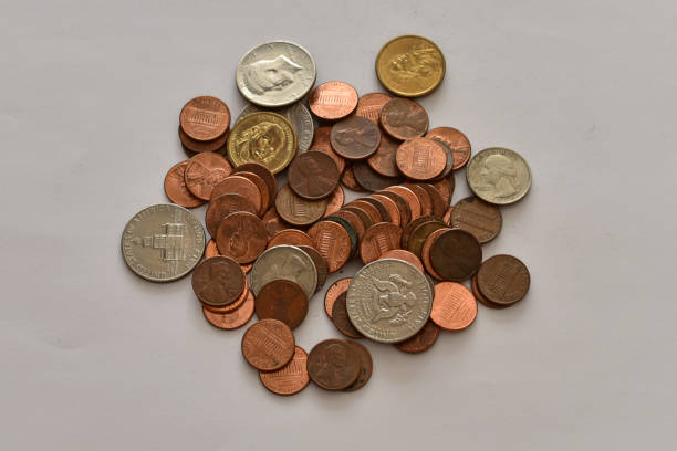 istock Pile of US coins on a white background 664178306