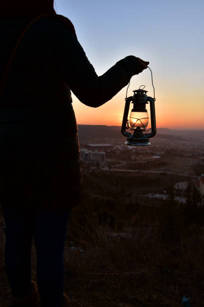 istock an oil lamp at the sundown landscape 664178458