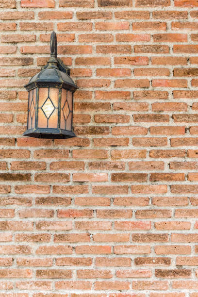 istock Exterior vintage lamp decorated on brick wall building. 664182198