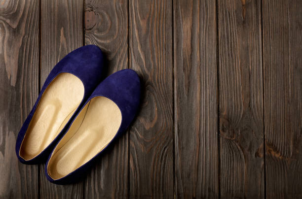Blue women's shoes (ballerinas) on wooden background. Blue women's shoes (ballerinas) on wooden background. Selective focus. womens blue suede shoes stock pictures, royalty-free photos & images