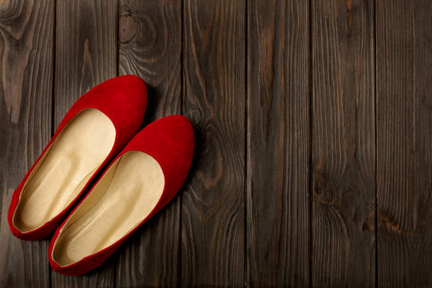 istock Red women's shoes (ballerinas) on wooden background. 664182326