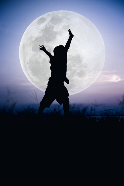 istock Silhouette of child enjoying and jumping at riverside. 664183304