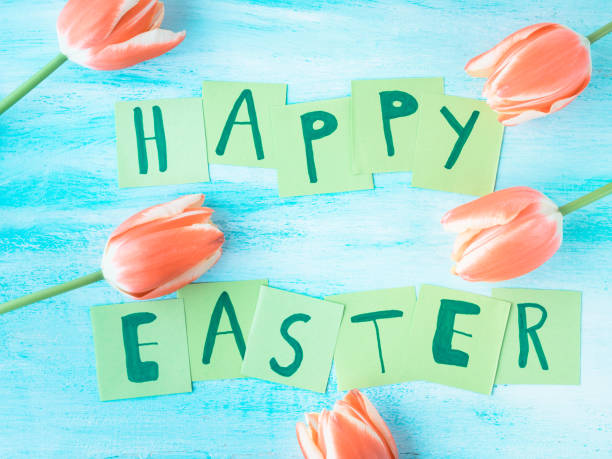istock Happy Easter background tulips flowers hand written letters 664186446