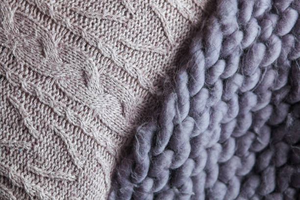 istock Cozy composition, closeup merino wool plaid in bed, warm and comfortable atmosphere. Knit background 664194914