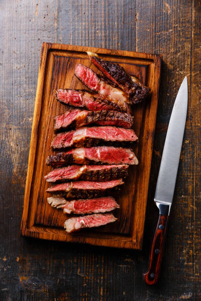 istock Ribeye steak on cutting board and kitchen knife 664195620