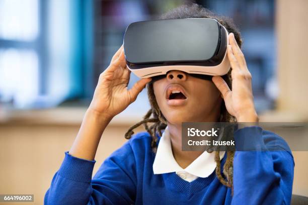 Afro American Student Using Virtual Reality Goggle Stock Photo - Download Image Now - Virtual Reality Simulator, Virtual Reality, Child
