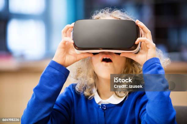 Cute Girl Using Virtual Reality Goggle At School Stock Photo - Download Image Now - Virtual Reality Simulator, Child, Education