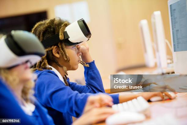 Mixed Race Group Of Students Using Virtual Reality Goggles Stock Photo - Download Image Now