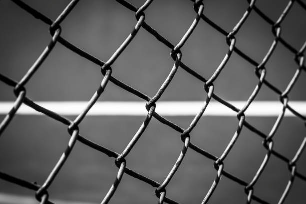 istock Close-up wire mesh steel with cort tennis background. 664198720