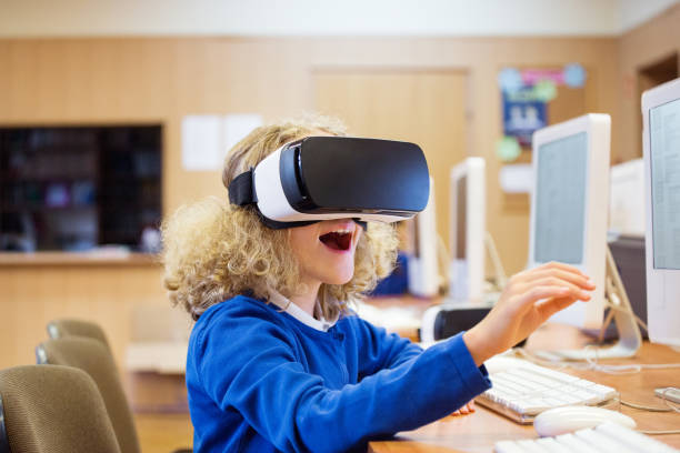 istock Cute girl using virtual reality goggle at school 664202526