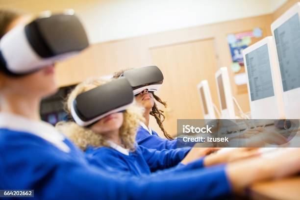 Mixed Race Group Of Students Using Virtual Reality Goggles Stock Photo - Download Image Now