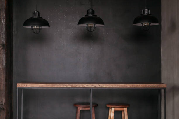 Dinning table set in loft style dining room with black lamps Dinning table set in loft style dining room with black lamps. brick cafe stock pictures, royalty-free photos & images