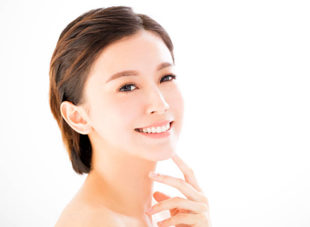 istock closeup   young  smiling woman face isolated on white 664203238