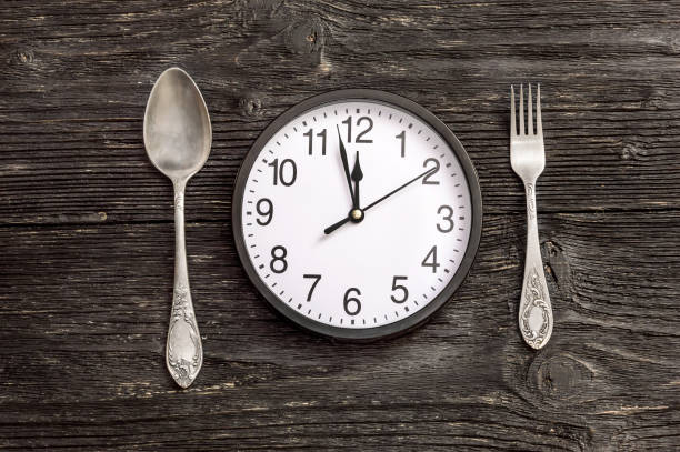 istock Clock with fork and spoon.Top view. Time to eat. 664206626