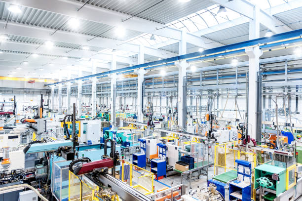 Factory interior & futuristic machines Horizontal color image of large group of modern machines in new factory. local products stock pictures, royalty-free photos & images