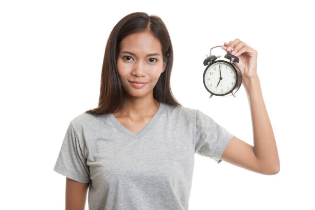 istock Young Asian woman with a clock. 664209996