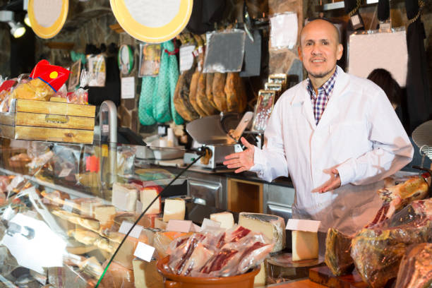 istock salesman selling cheese and jamon 664214378