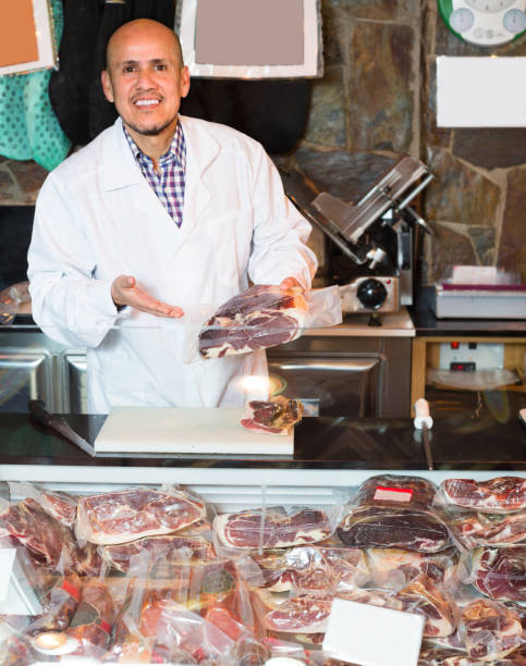 istock Male seller with wurst and jamon 664214382