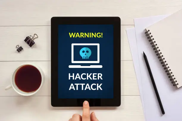 Photo of Hacker attack concept on tablet screen with office objects