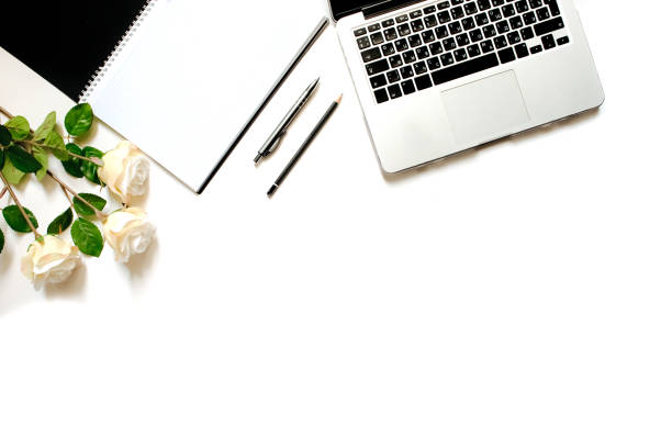 istock Modern minimalistic work place. White office desk table with laptop keyboard, pen, white roses. Top view with copy space, flat lay 664221798