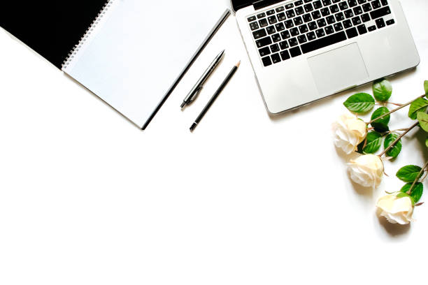 istock Modern minimalistic work place. White office desk table with laptop keyboard, pen, office plant, white roses. Top view with copy space, flat lay 664221988