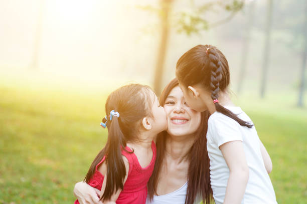 istock Daughters kissing mother. 664224566