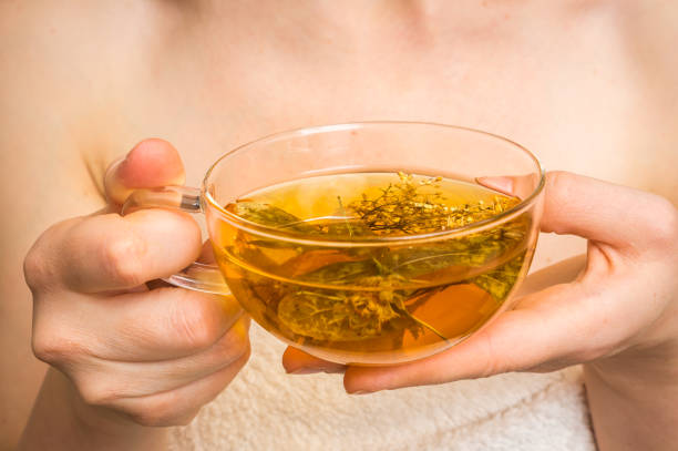 istock Beautiful woman with hot tea cup in her hands 664224808