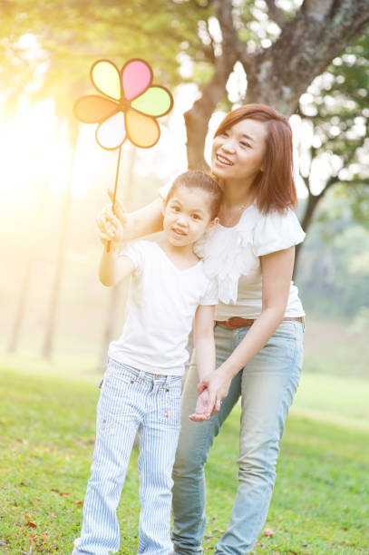 istock Mother and children playing in nature park. 664225054