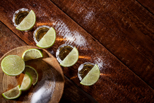 istock Tequila shots on wooden background 664225336