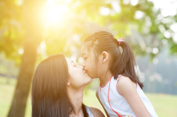 istock Mother and daughter kissing. 664225430