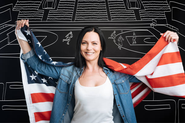istock Happy patriotic woman supporting her team 664226066