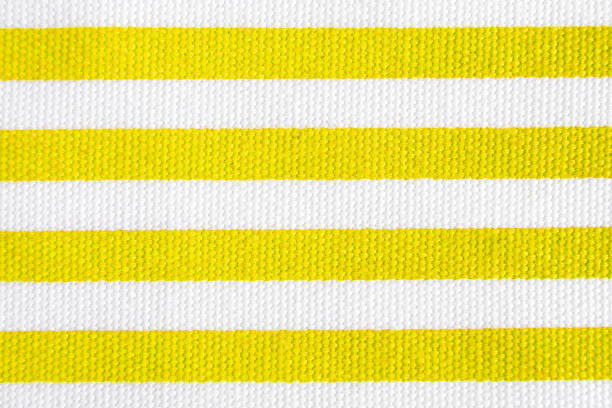 Textile background with yellow and white stripes. Fabric texture
