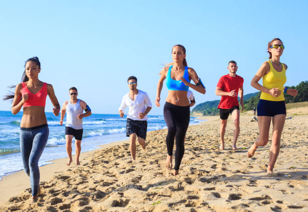istock Friends jogging on beach 664235494