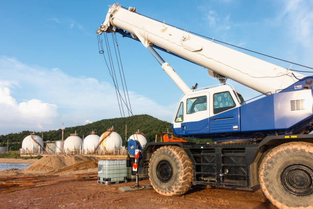 istock Mobile crane lifting on petrochemical plant background. 664238214