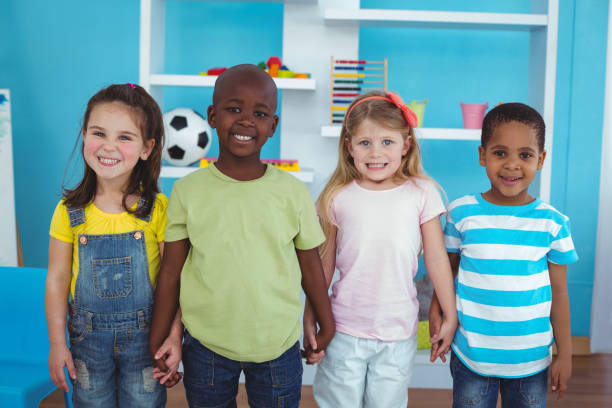istock Happy kids holding hands together 664242442