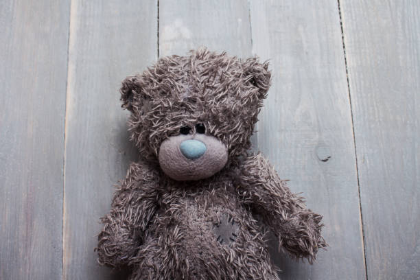 istock toy teddy bear on wooden background 664242446
