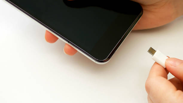 istock Female hand plugging charger cell phone smartphone 664244998