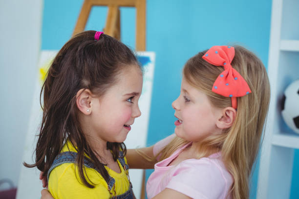istock Happy girls hugging each other 664245186