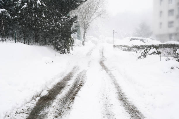 istock Wheel Tracks on the Road Covered with Snow 664245604