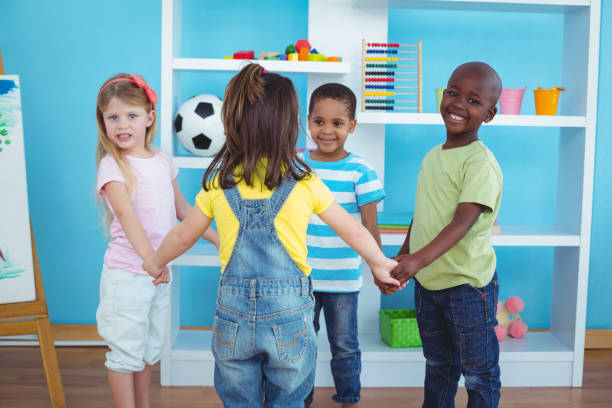 istock Happy kids holding hands together 664245726