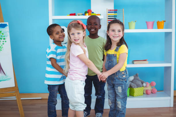 istock Happy kids holding hands together 664245892