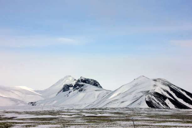 istock Mountain peaks covered with snow and with a blue sky above them 664246012