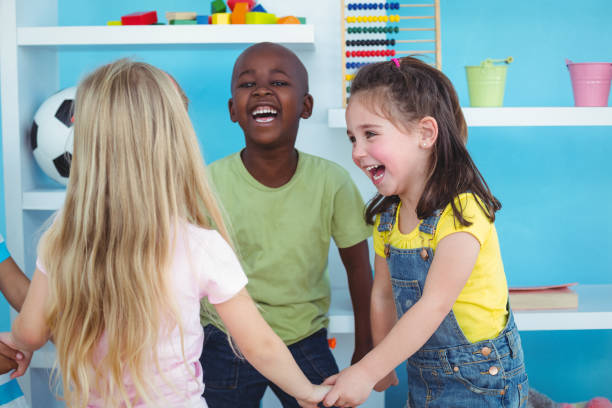 Happy kids holding hands together in the bedroom