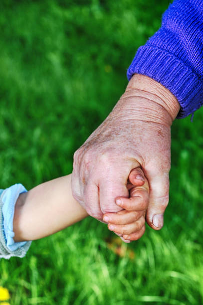istock grandmother and child hands 664246128