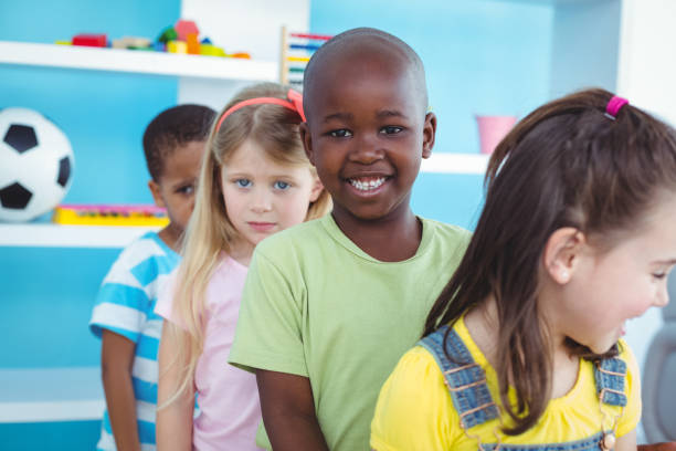 istock Happy kids standing in a line 664246436