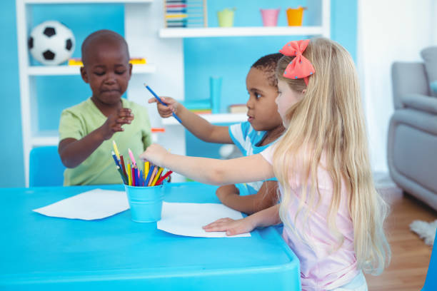 istock Happy kids enjoying arts and crafts together 664246564